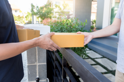 delivery service hading a package to a customer