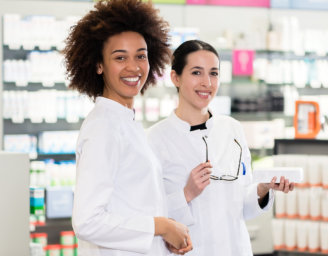 two pharmacists looking at camera
